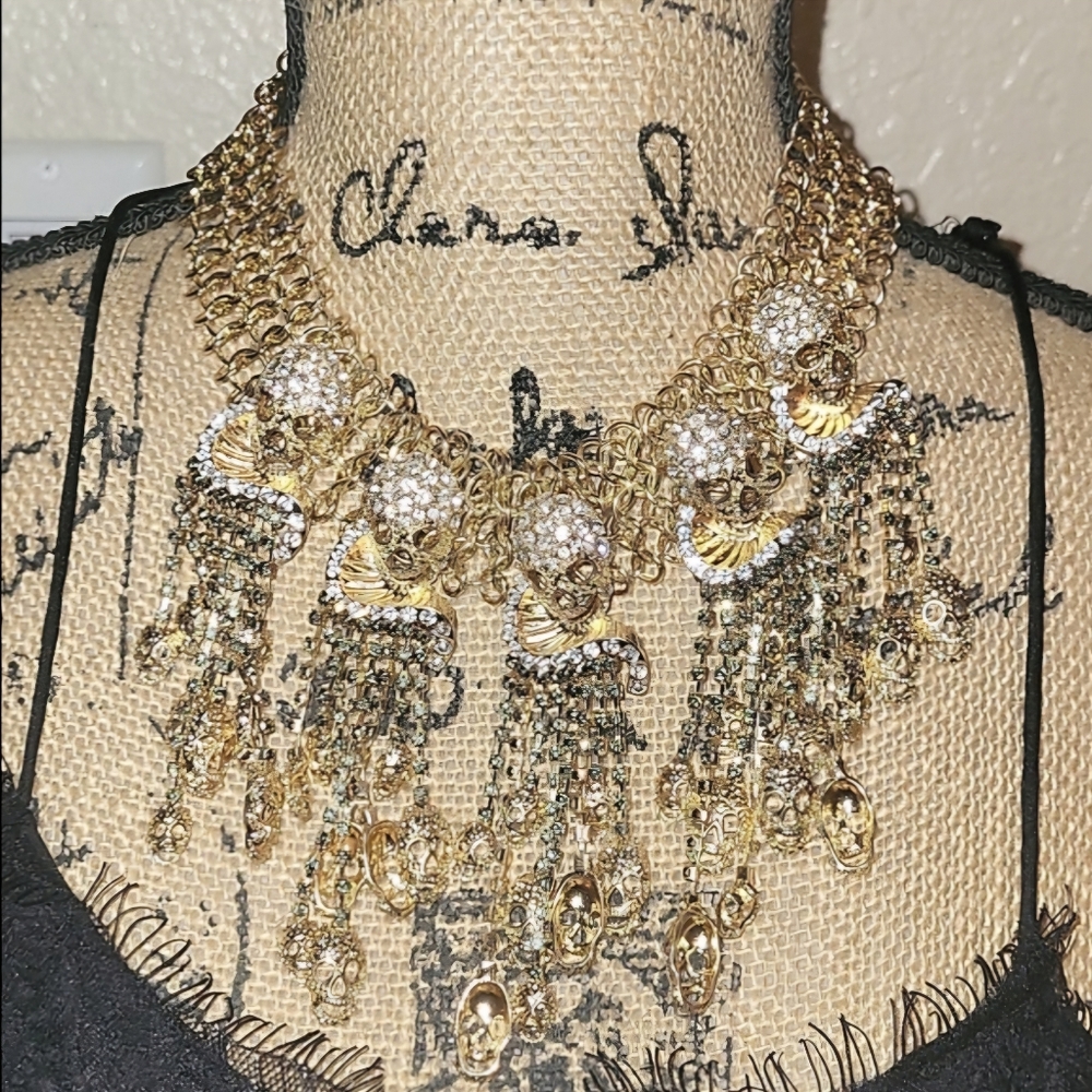 Anthropologie gold and clear statement necklace With Cascading Skulls